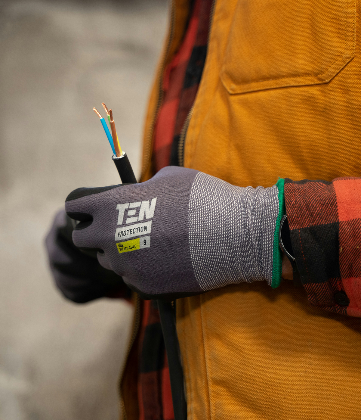 hangs wearing gloves holding bare wires